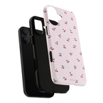 Exploded cherry-pattern case showing a vertical dual-camera phone, liner and shell #iphone-16