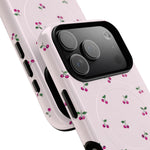 Close-up of overlapping cherry-pattern cases with wide triple-camera opening #iphone-17-pro-max