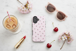 Cherry-pattern pink vertical dual-camera case in a marble flat lay #iphone-16-plus
