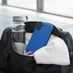 Cobalt blue vertical-dual-camera case in a gym bag with towel and water bottle #iphone-16