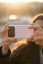 Hand holding fully striped case - taking photo