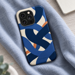 Indigo Loom glossy case with square triple-camera opening resting on blue-gray linen