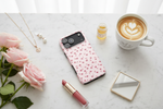 Lifestyle flat lay - iPhone 17 with pink rose case on desk