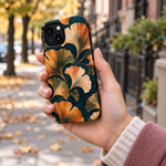 Adult woman holding the Nocturne Ginkgo iPhone 13 case outdoors #iphone-13