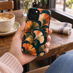 Adult woman holding the Nocturne Ginkgo iPhone 13 Pro Max case at a cafe #iphone-13-pro-max