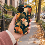 Adult woman holding the Nocturne Ginkgo iPhone 14 case outdoors #iphone-14