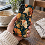 Adult woman holding the Nocturne Ginkgo iPhone 14 Plus case at a cafe #iphone-14-plus