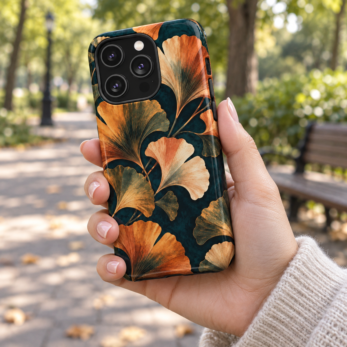 Adult woman holding the Nocturne Ginkgo iPhone 14 Pro case outdoors #iphone-14-pro