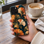 Adult woman holding the Nocturne Ginkgo iPhone 14 Pro Max case at a cafe #iphone-14-pro-max