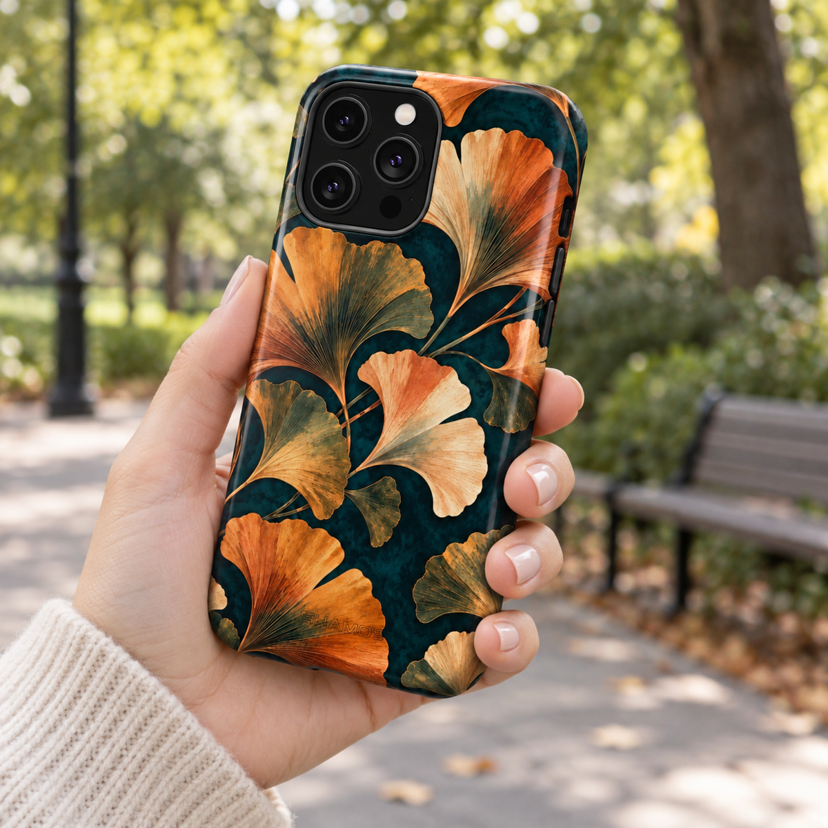 Adult woman holding the Nocturne Ginkgo iPhone 14 Pro Max case outdoors #iphone-14-pro-max