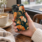 Adult woman holding the Nocturne Ginkgo iPhone 15 case at a cafe #iphone-15