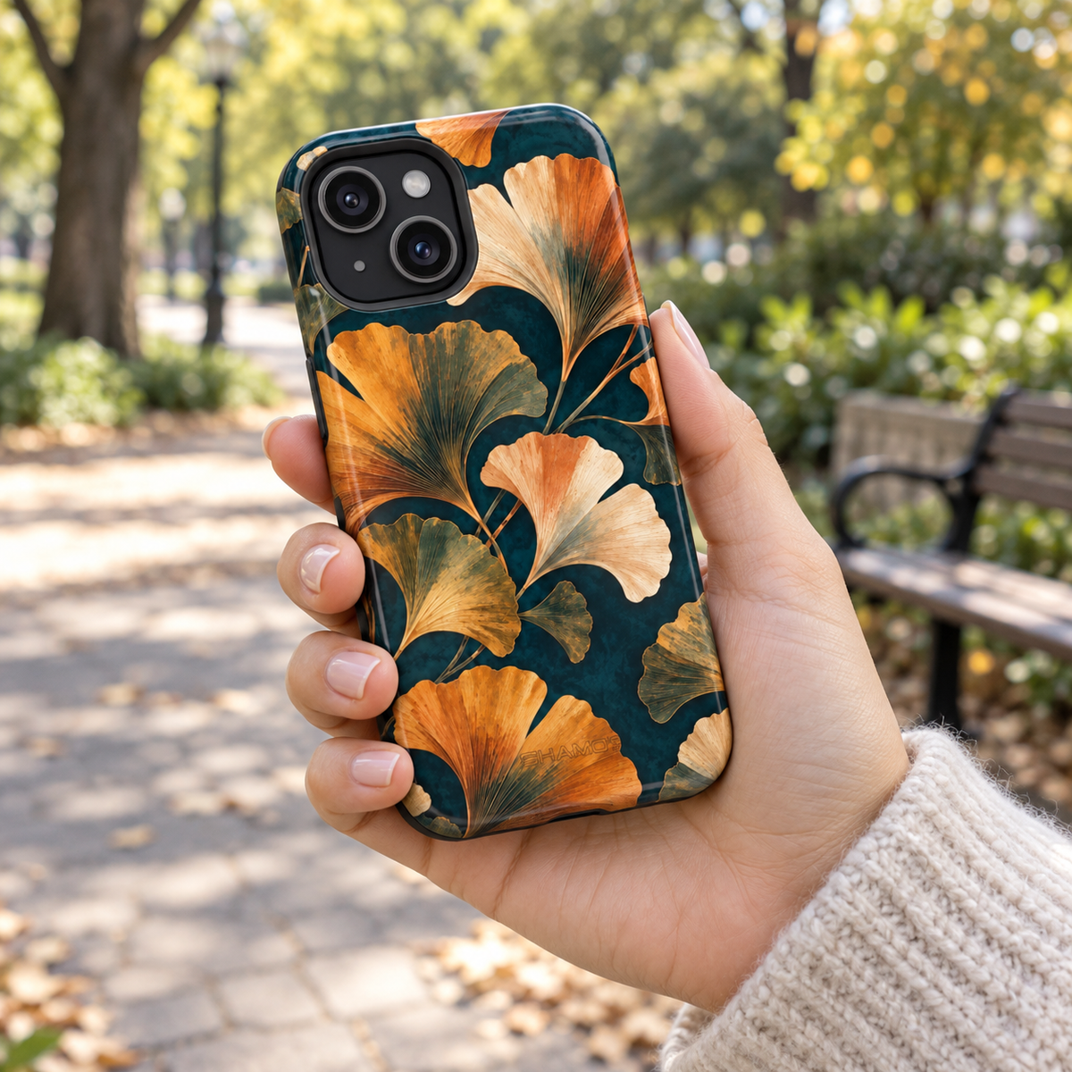 Adult woman holding the Nocturne Ginkgo iPhone 15 case outdoors #iphone-15