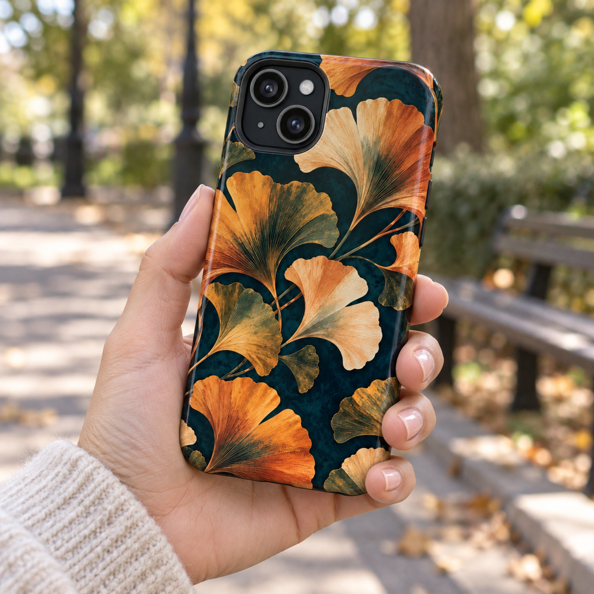 Adult woman holding the Nocturne Ginkgo iPhone 15 Plus case outdoors #iphone-15-plus