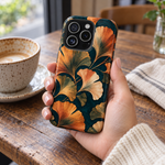 Adult woman holding the Nocturne Ginkgo iPhone 15 Pro case at a cafe #iphone-15-pro