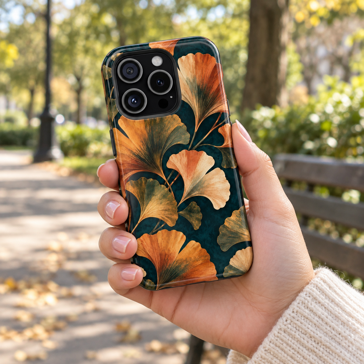 Adult woman holding the Nocturne Ginkgo iPhone 15 Pro case outdoors #iphone-15-pro