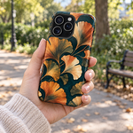 Adult woman holding the Nocturne Ginkgo iPhone 15 Pro Max case outdoors #iphone-15-pro-max