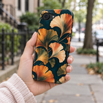 Adult woman holding the Nocturne Ginkgo iPhone 16e case outdoors #iphone-16e