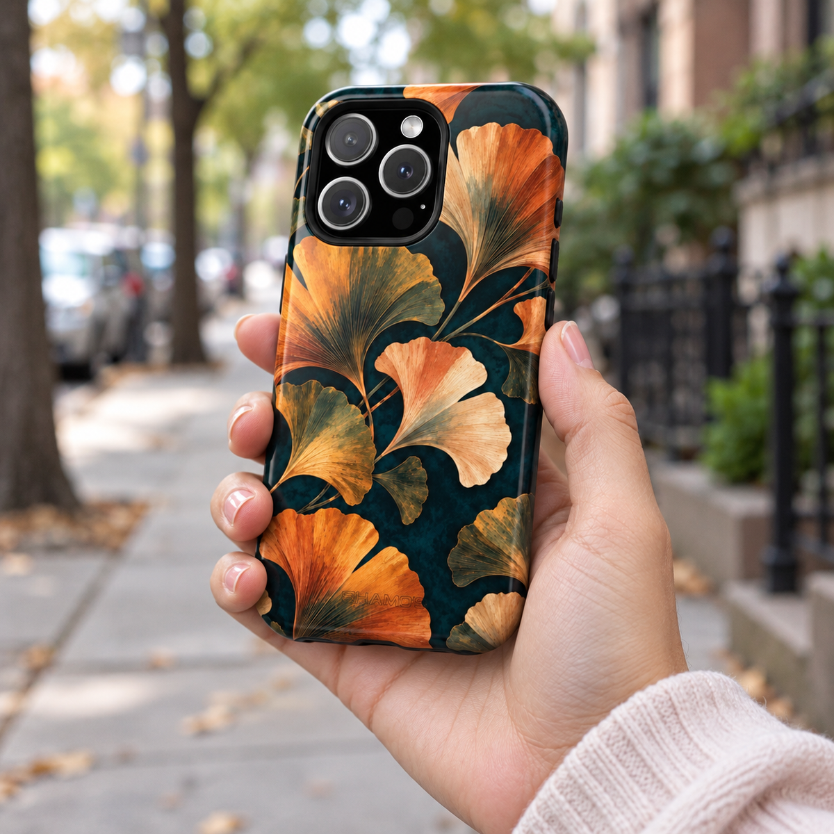 Adult woman holding the Nocturne Ginkgo iPhone 16 Pro case outdoors #iphone-16-pro