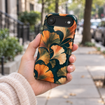 Adult woman holding the Nocturne Ginkgo iPhone 17 Air case outdoors #iphone-17-air