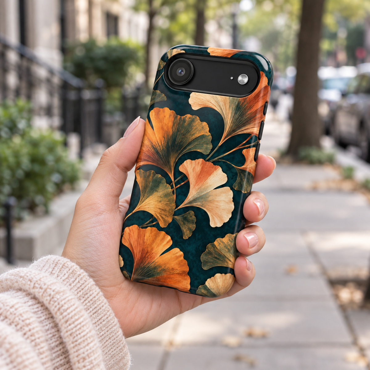 Adult woman holding the Nocturne Ginkgo iPhone 17 Air case outdoors #iphone-17-air