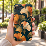Adult woman holding the Nocturne Ginkgo iPhone 17e case outdoors #iphone-17e