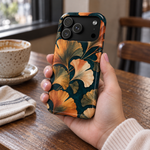 Adult woman holding the Nocturne Ginkgo iPhone 17 Pro case at a cafe #iphone-17-pro