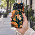 Adult woman holding the Nocturne Ginkgo iPhone 17 Pro Max case outdoors #iphone-17-pro-max