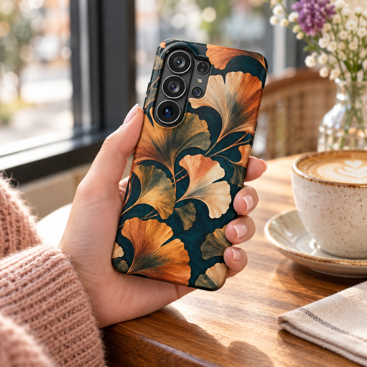 Adult woman holding the Nocturne Ginkgo Samsung Galaxy S26 Ultra case at a cafe #samsung-galaxy-s26-ultra